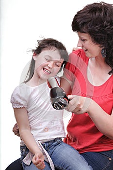 Woman and daughter Little girl dries hair isolated