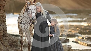 Woman with daughter and mottled horse full hd