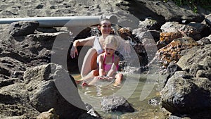 Woman with daughter relaxing in thermal waters