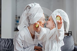 Woman with daughter in white bathrobes