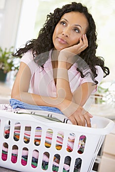Woman Daydreaming Over Washing Basket