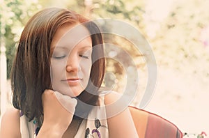 Woman daydreaming in peaceful garden