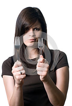 Woman deciding between plastic and reusable forks photo