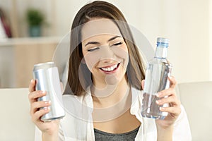 Woman deciding between water or soda refreshment photo