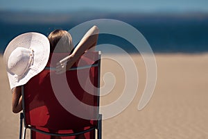 Woman on a deckchair at the beach photo