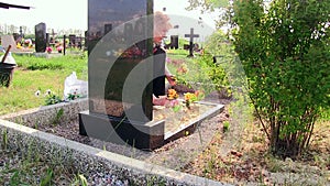 woman decorates relative`s grave