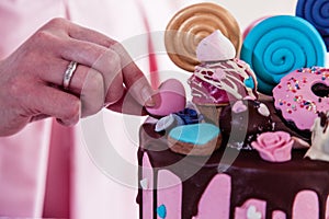 Woman decorating a candy cake