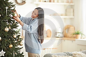 Woman decorating Christmas tree