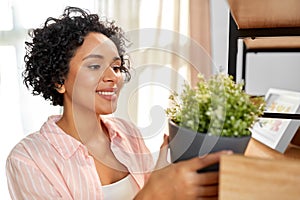 woman decorating home with flower or houseplant