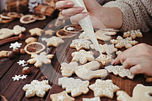 Woman decorating homemade gingerbread cookies