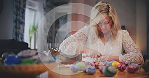 Woman decorating Traditional Easter Eggs Using Old Traditional Technique.