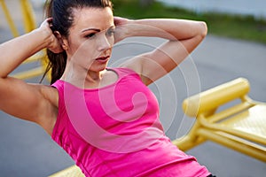 Woman in deep concentration doing situps