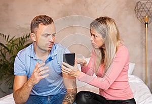 Woman demanding her man to explain what`s on the phone