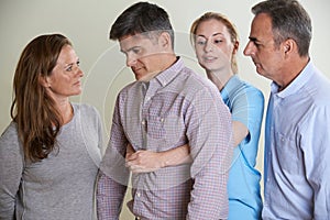 Woman Demonstrating Heimlich Maneuver In First Aid Class photo