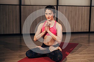 Woman demonstrating Sukhasana or Easy yoga pose