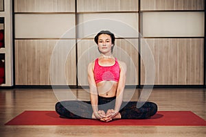Woman demonstrating Sukhasana or Easy yoga pose