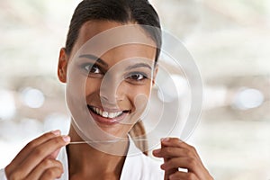 Woman, dental and smile with floss, self care and portrait for health in bathroom. Person, cleaning and healthcare for