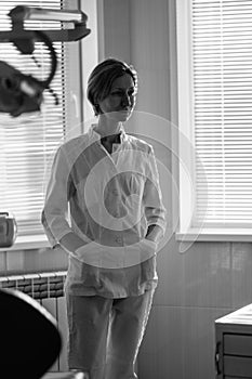 A woman dentist in her medical office. Black and white photo.