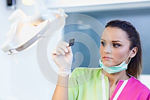 Woman dentist looking at a dental radiography