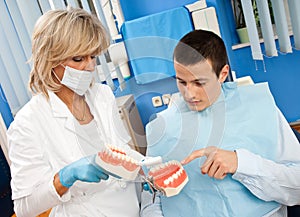 Woman dentist with male patient