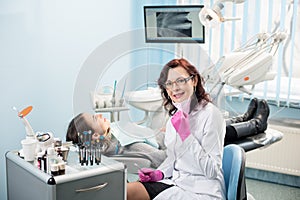 Woman dentist with patient in the dental clinic