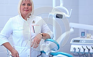 Woman dentist standing in her office smiling