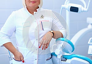 Woman dentist standing in her office smiling
