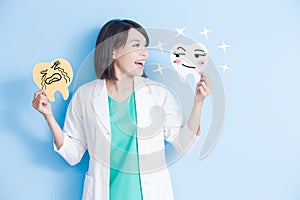 Woman dentist take tooth board