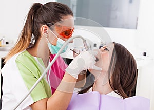 Woman dentist working with the driller