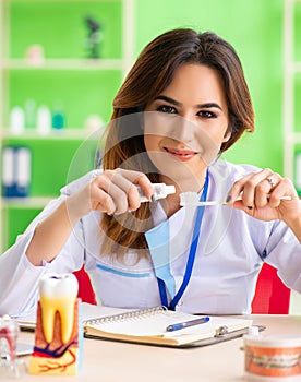 Woman dentist working on teeth implant