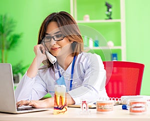 Woman dentist working on teeth implant