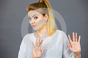 Woman deny something showing stop gesture with hands