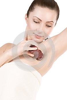 Woman with deodorant stick under her armpit