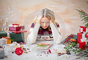 Woman depressed with Christmas gift clutter photo