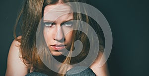 Woman in depression and despair crying on black dark