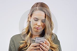 Woman, depression and sad with smartphone for social media post in grey background, technology and emotion. Girl, mental