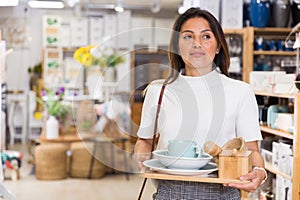 Woman designer choosing accessories in shop for decor