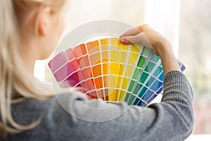 Woman designer choosing design color from swatch palett