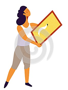 Woman designer holding framed picture for home decor
