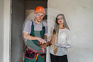 Woman designer and man with wooden sampler