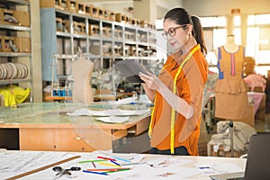 Woman designer using digital table touch pad