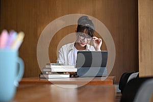 Woman designer working with computer tablet in modern office.