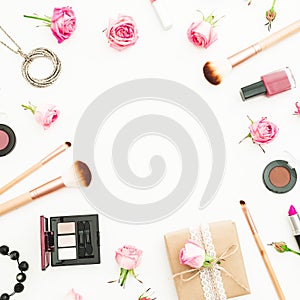 Woman desk with gift box, pink roses, cosmetics, diary on white background. Top view. Flat lay. Valentines day frame composition.