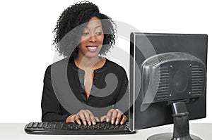 Woman on desktop computer photo