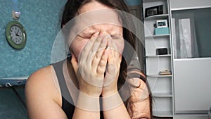 Woman desperate at home. Victim of Abuse Violence. Caucasian girl with long brown hair crying in her room with blue and white. Fat