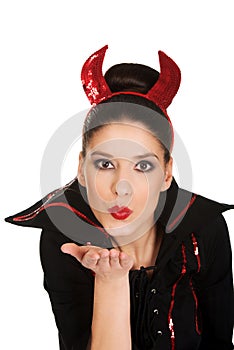 Woman in devil costume blowing a kiss.