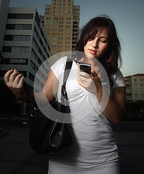 Woman dialing a cell phone