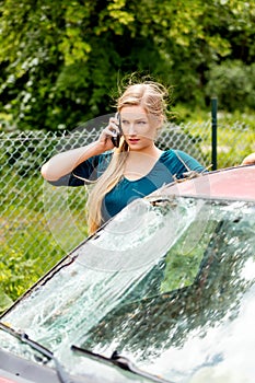 Woman dialing her phone after car crash