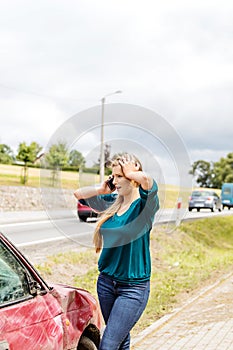 Woman dialing her phone after car crash