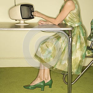 Woman dialing television.